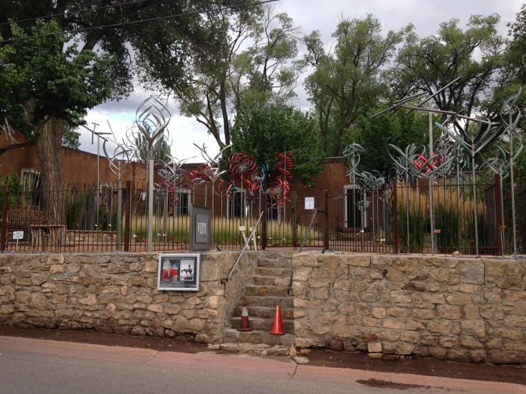 an open gate in front of a stone wall