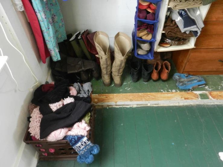 a small room with many shoes and a bench