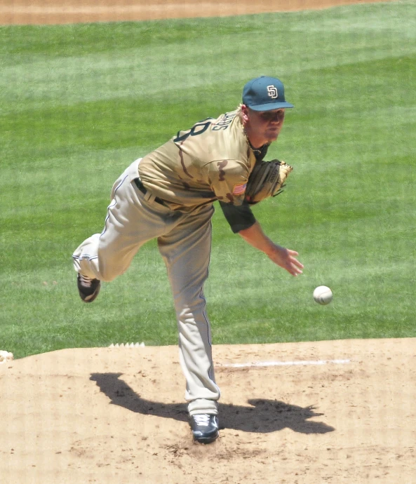 a baseball player is winding up for the pitch