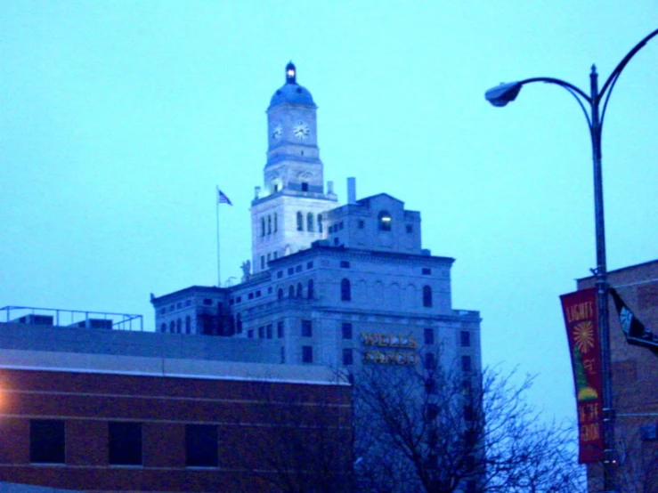 a building has a clock on it and is white