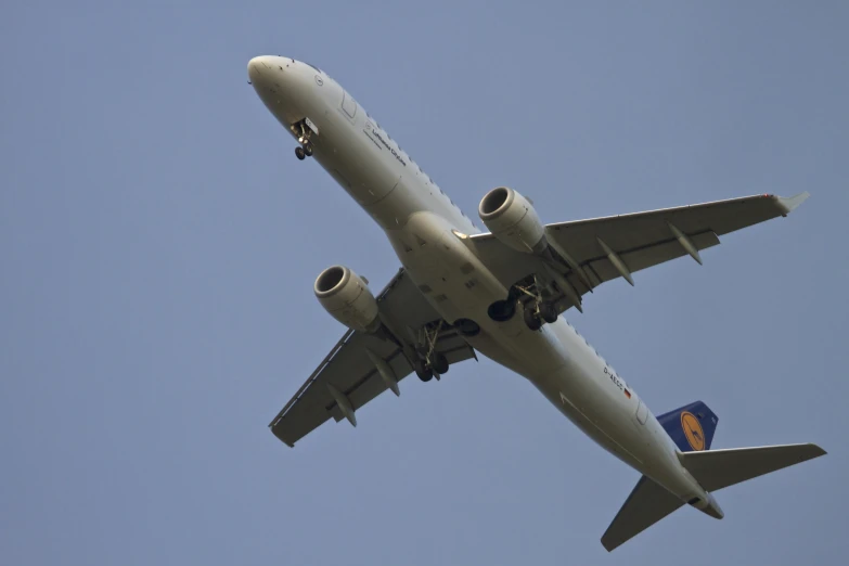 an airplane is flying through the blue sky