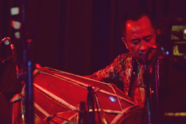 a man playing the drums at a band