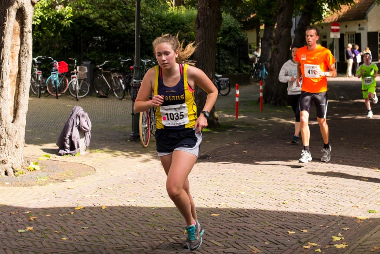 a woman running a marathon on a brick road