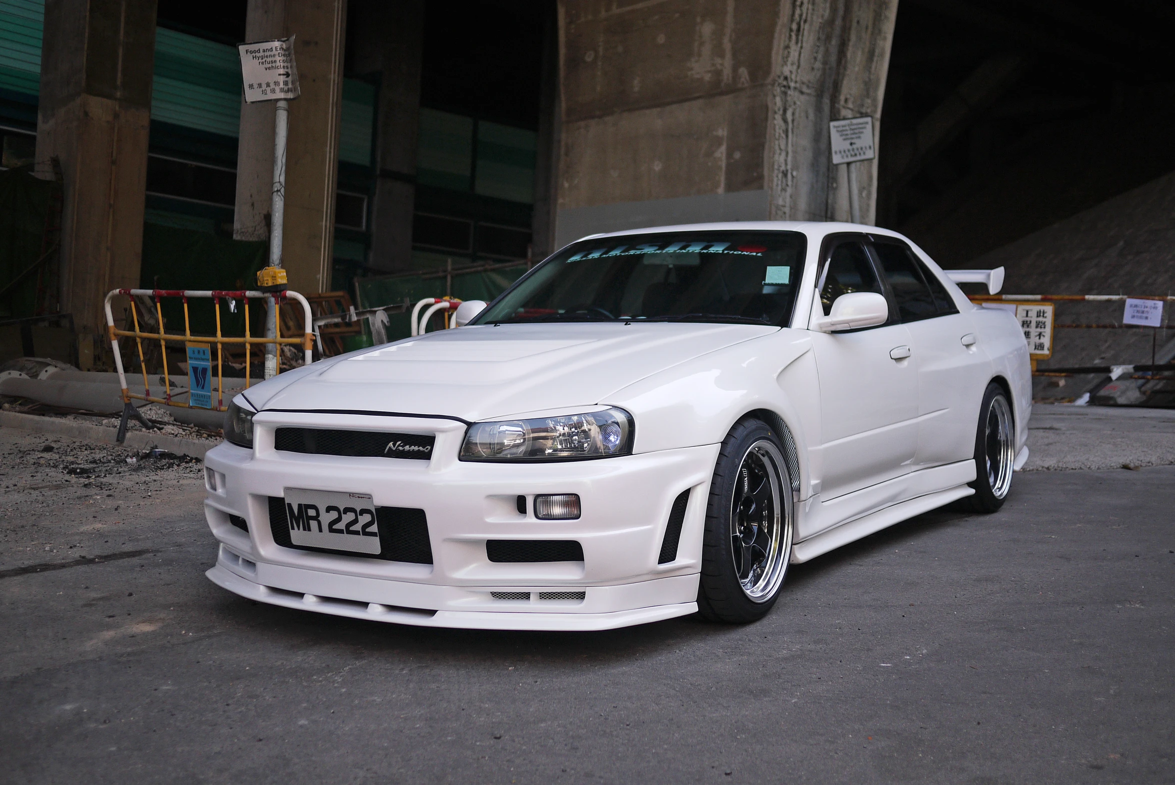 a white car sitting in front of a building on the street