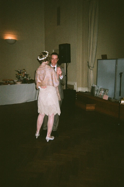 a bride and groom are dancing in a very large room