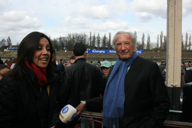 an older man and woman are at a horse race