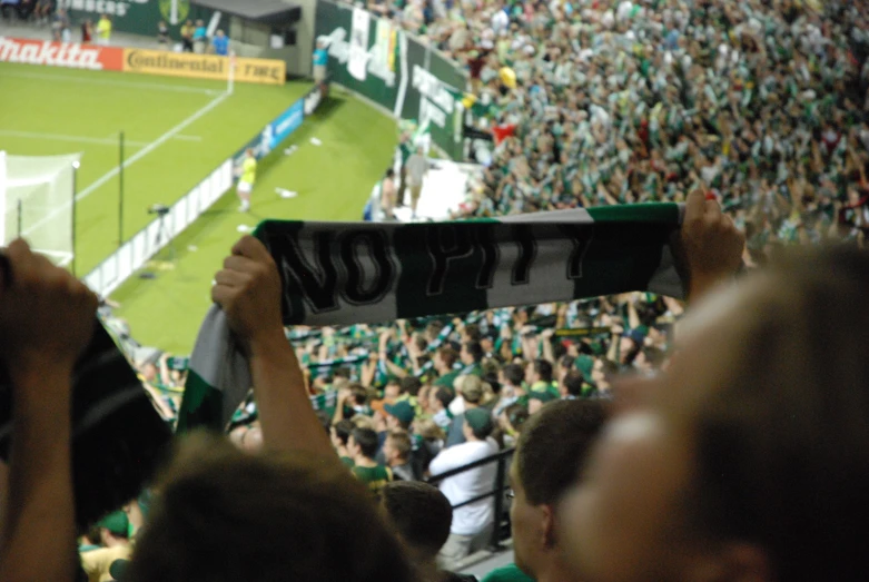 the fans hold up signs to welcome their team at the game