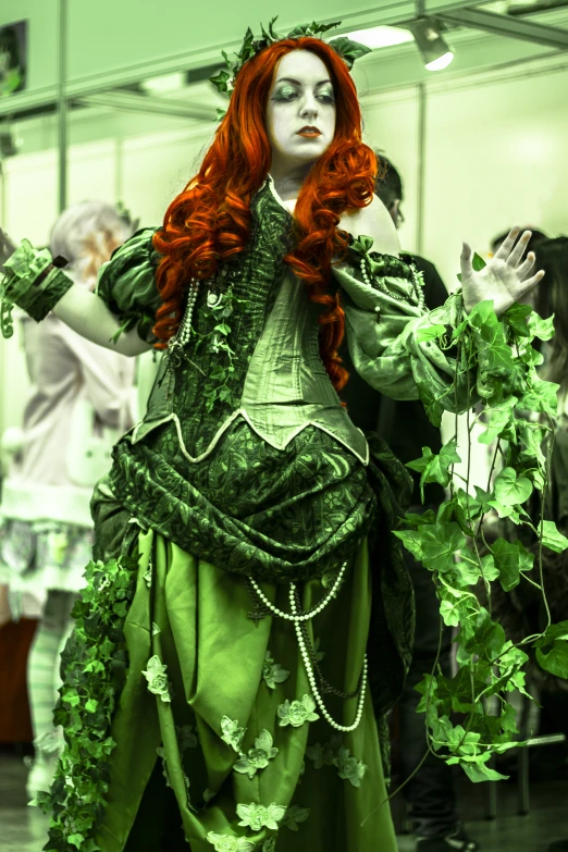 a woman in a green dress is dressed in costume