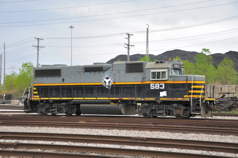 a grey and yellow train with two other tracks