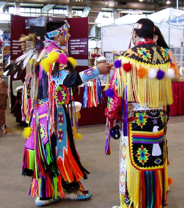 two people are dressed up and talking