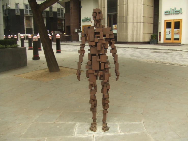 a statue of a man standing on the sidewalk