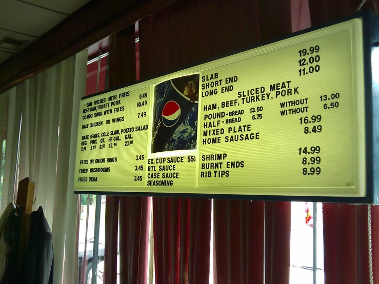 a large menu board hanging from a wall