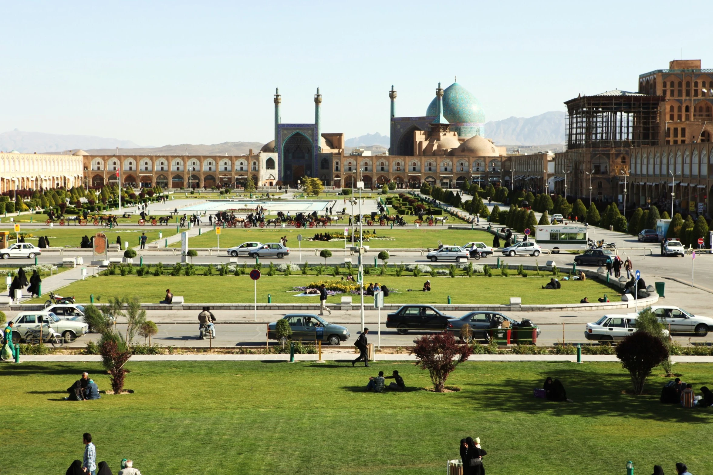 view of the lawn, fountain, and old building across the street