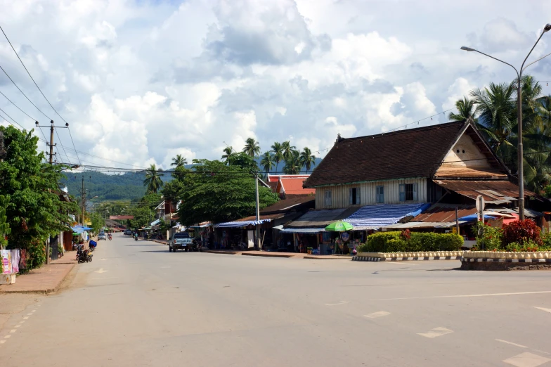 a street with stores and umbrellas in front