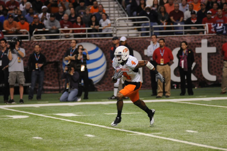 a football player running down the field in a game