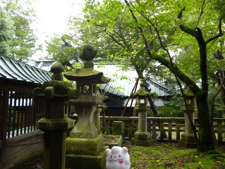 a garden with a pagoda and a garden statue