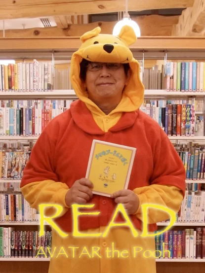 a person in a winnie the pooh costume holding a book
