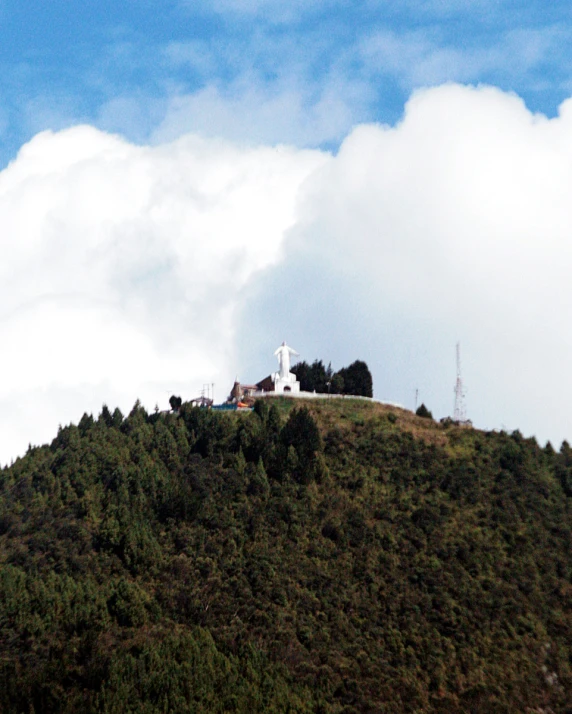 a large hill that has a small house on top