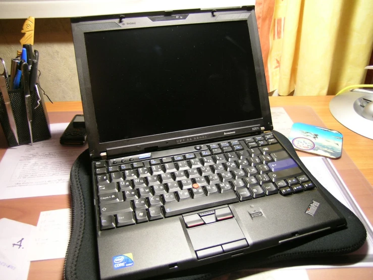 a black laptop computer sitting on top of a desk