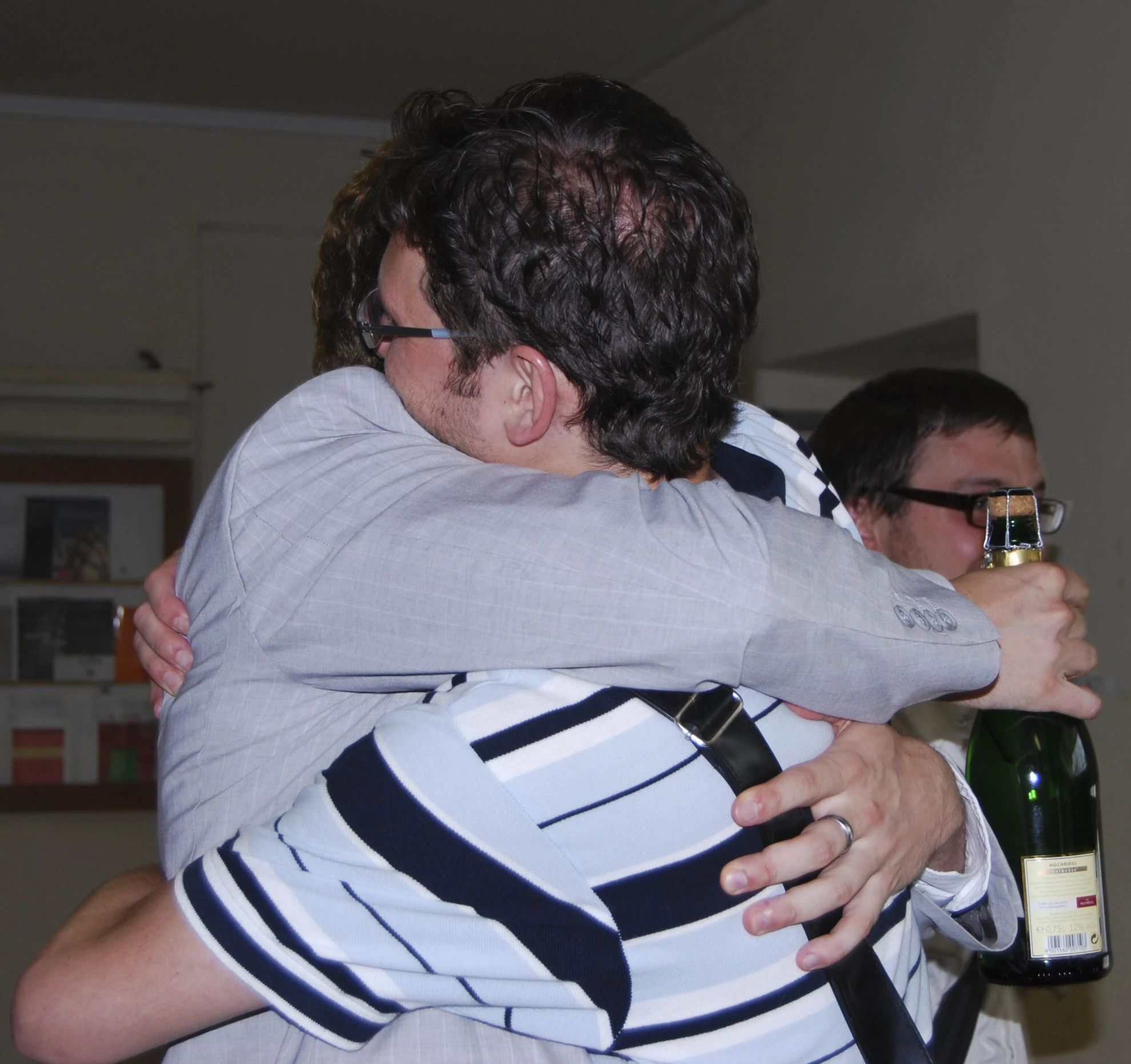 two people hug each other and hug with glasses