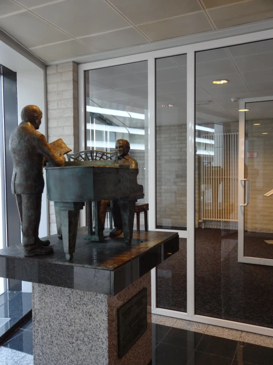 the sculpture is playing chess outside the building