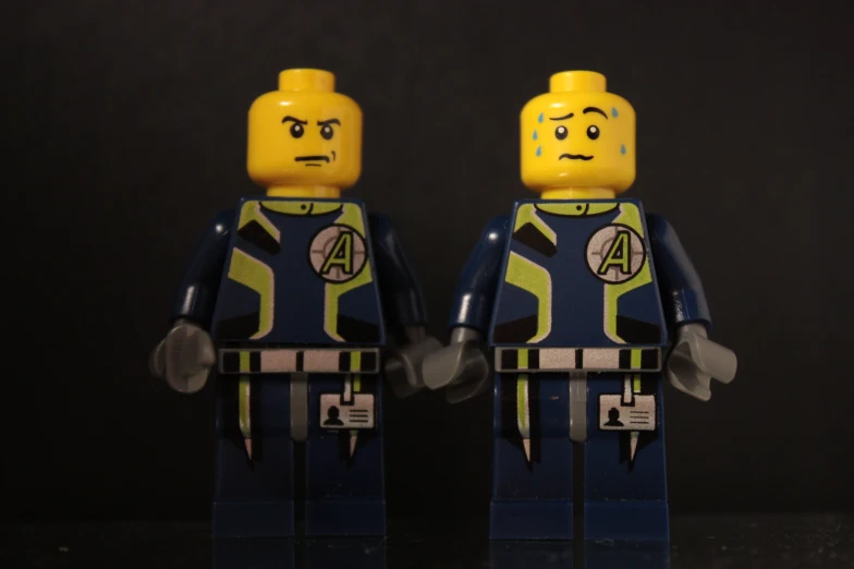 two lego toy characters posed for a po