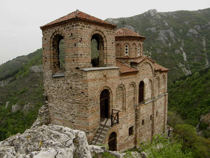 an abandoned castle atop the side of a cliff