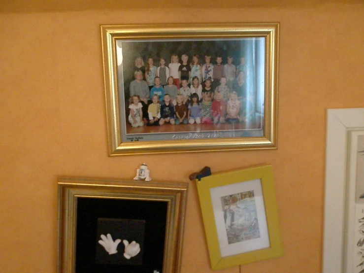 an arrangement of family pictures hanging on a wall