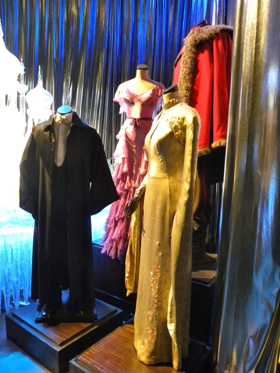 several mannequins displayed in a window with blue ds