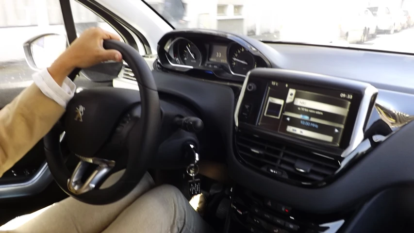 a person driving a vehicle with the view of the dashboard