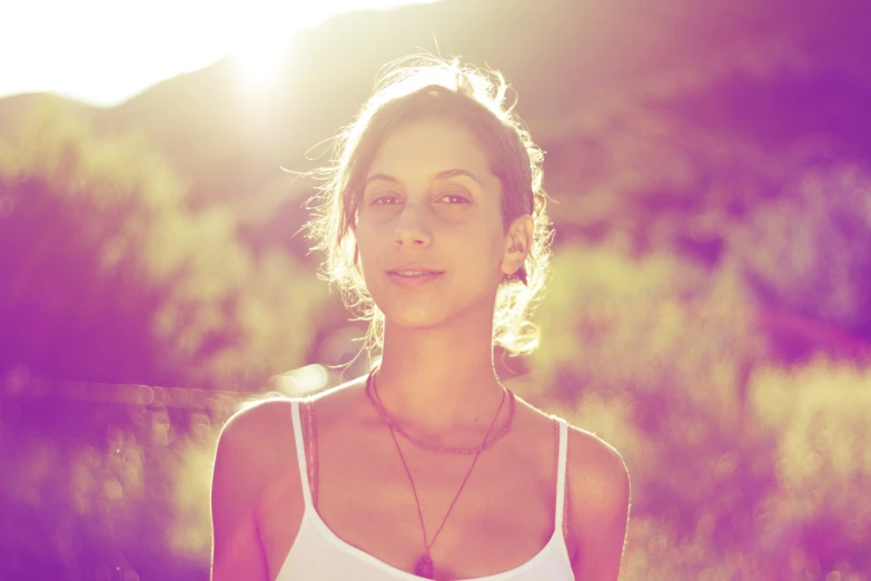 a woman posing for a picture wearing a white shirt