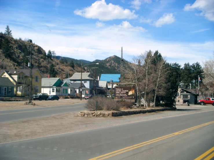 a stop sign is near some buildings and trees