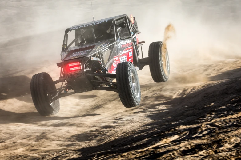 a jeep driving on the side of a dirt road