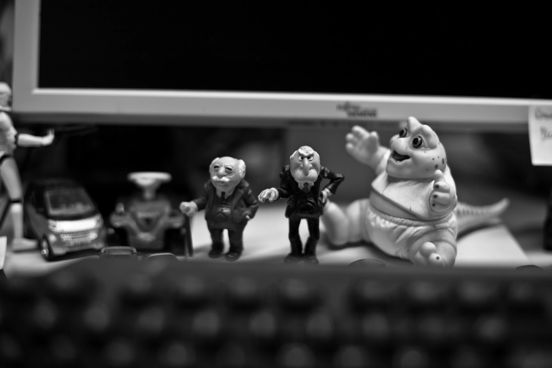 small figurines are shown sitting on a computer