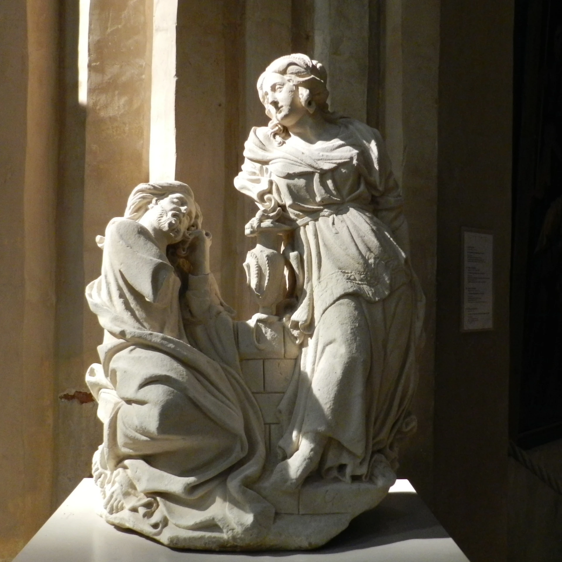 a statue with a man holding a womans hand