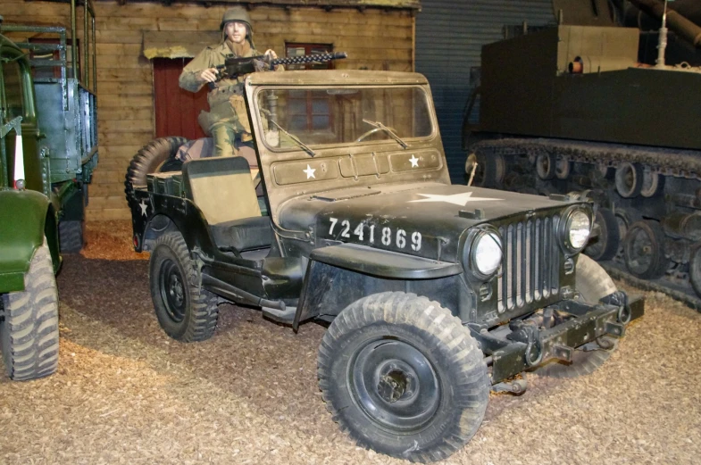 an army jeep parked in front of a military tank