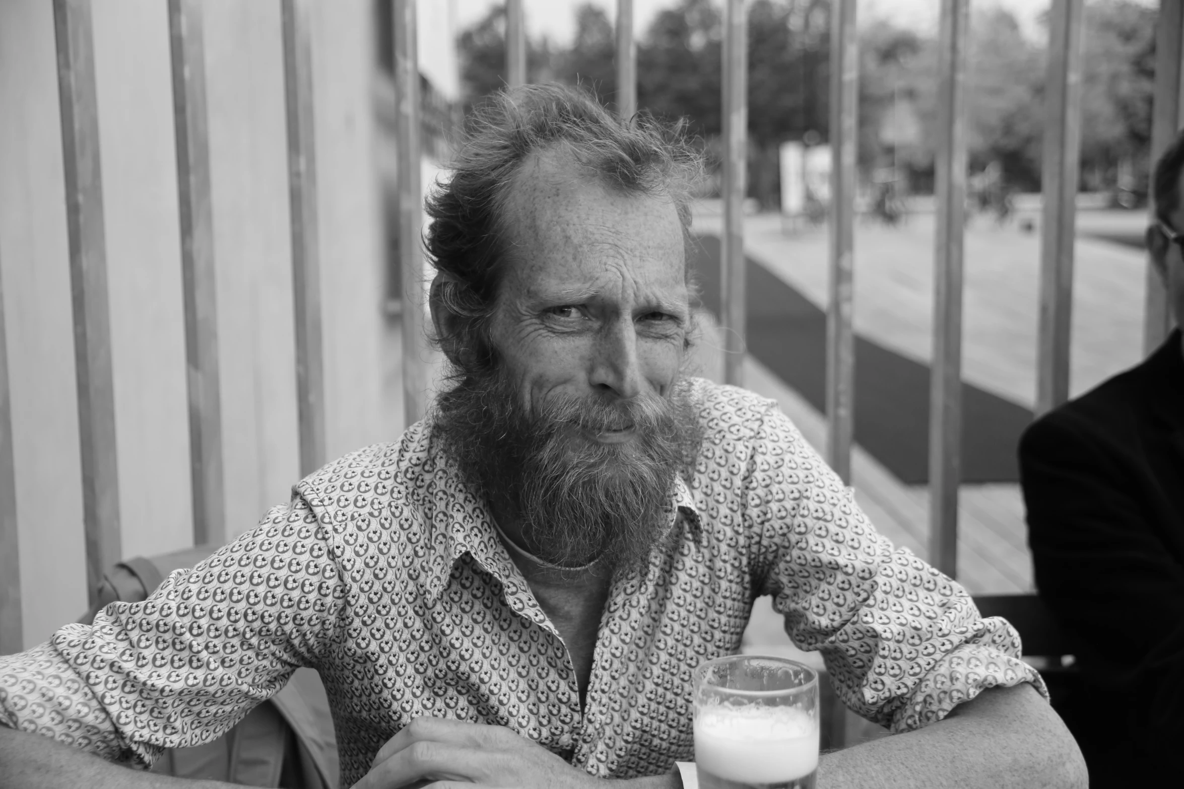 a man holding a glass in his hand at a table