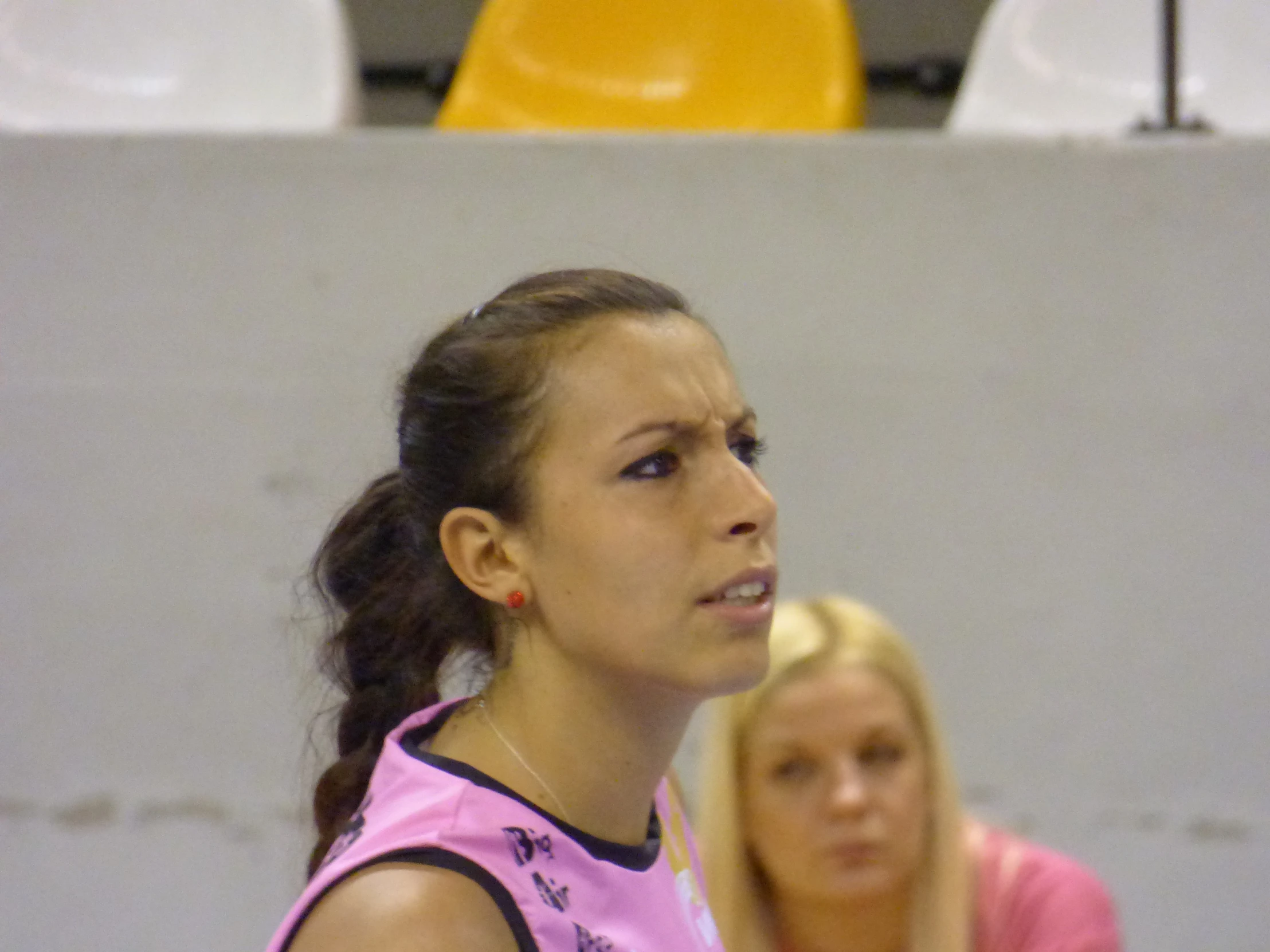 young women playing tennis on an indoor court