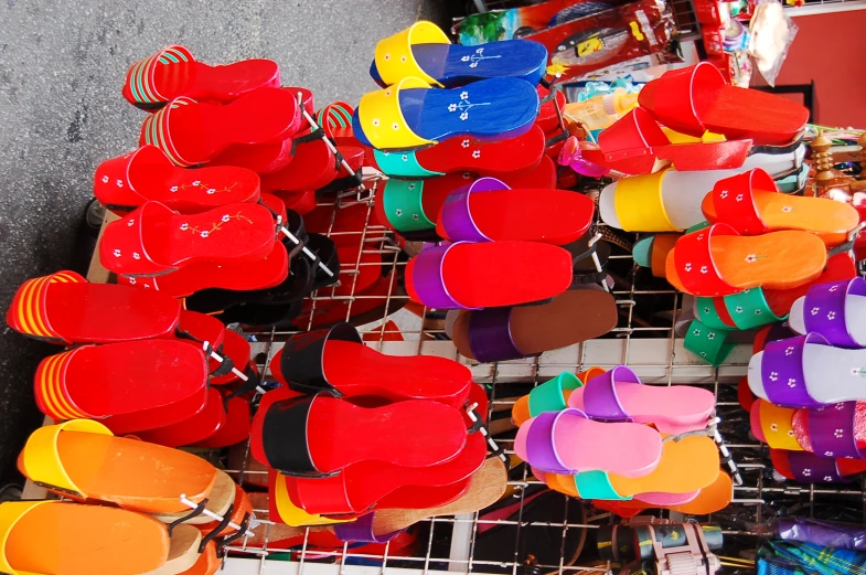 a bunch of different colored shoes hanging on a rack