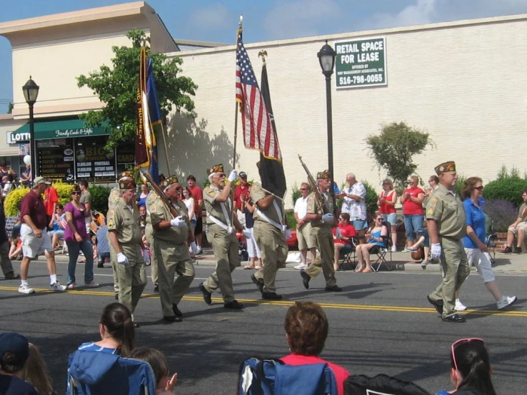 people dressed in all military uniforms with flags on parade