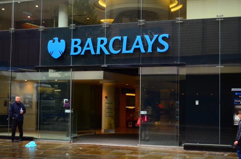 a storefront with two security personnel standing outside it