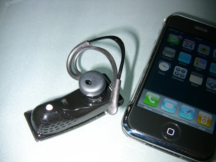 a cell phone and headphones on a white table