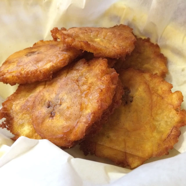 fried food in a paper bag cut up and stacked on top of each other