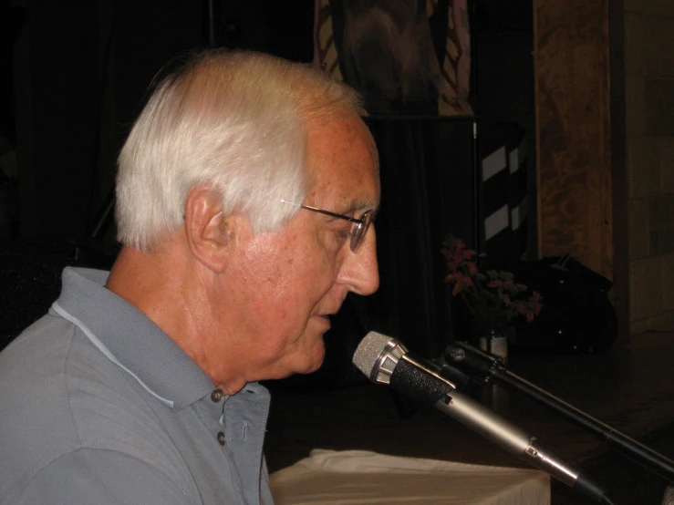 a man is listening into a microphone