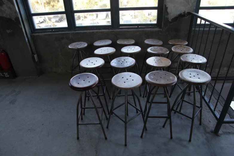 a collection of many chairs are positioned in a circle