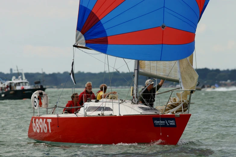 three people are on a small boat in the ocean