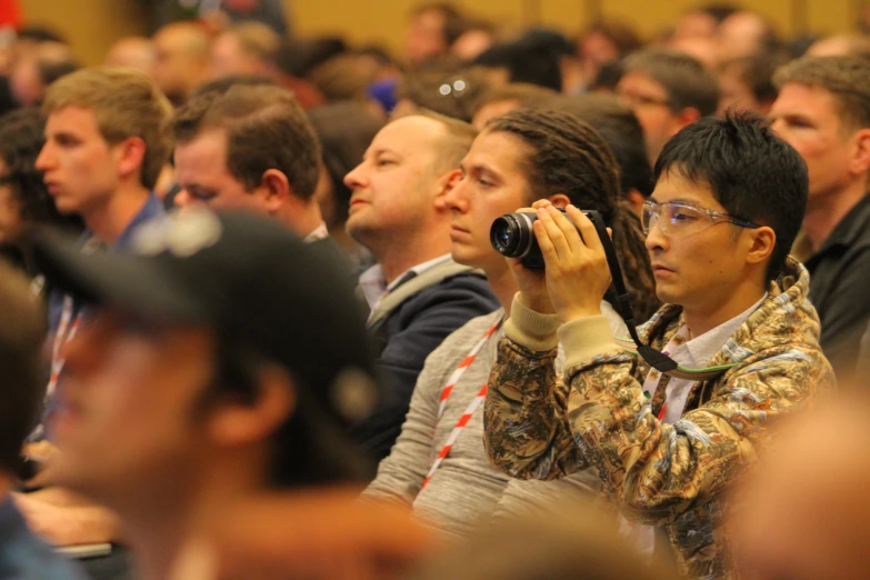 a crowd of people with cameras in front of them