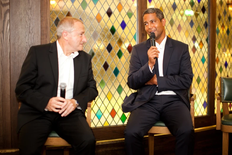 two men sitting and talking to each other