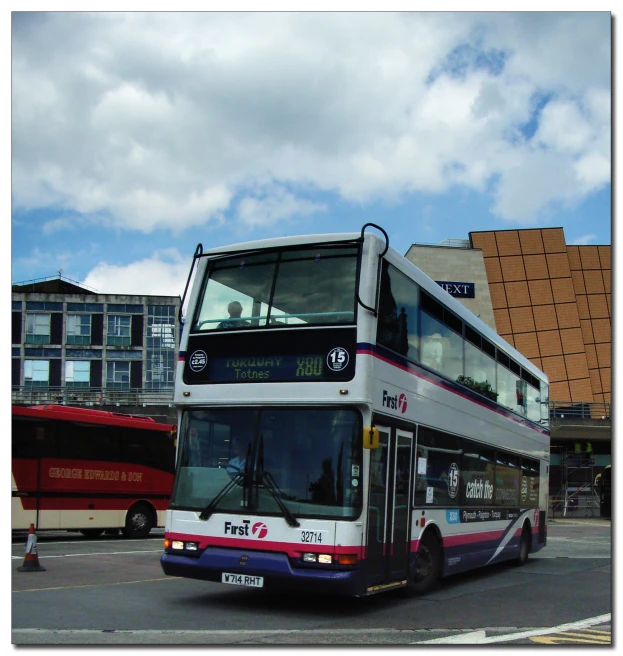 a double decker bus is parked at the side of the road