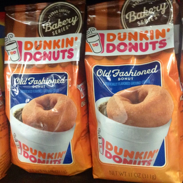 three bags of dunkin donuts sitting on top of a shelf